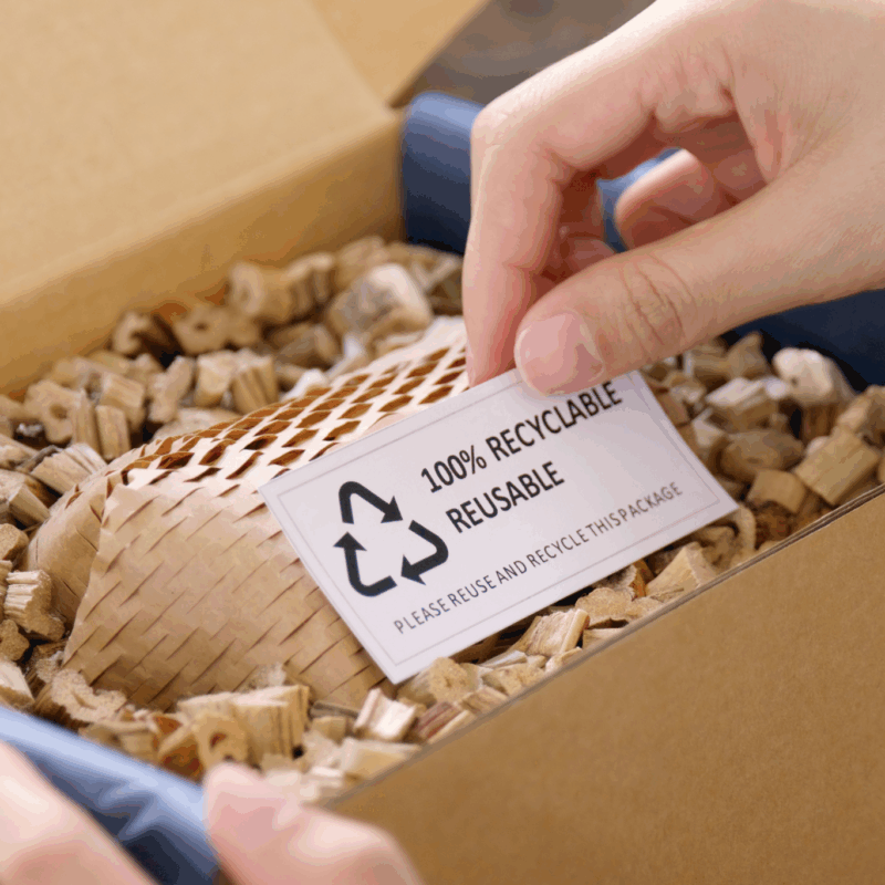 Person holding a box which is made of 100% recycled material